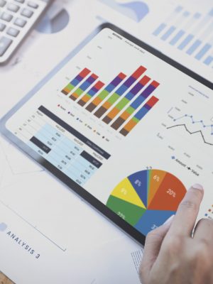 Businesswoman using a tablet to analysis graph company finance s Businesswoman using a tablet to analysis graph company finance strategy statistics success concept and planning for future in office room.